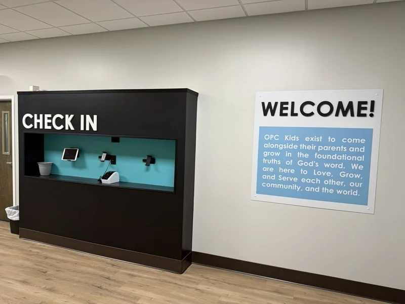 An image of the welcome and check-in signage